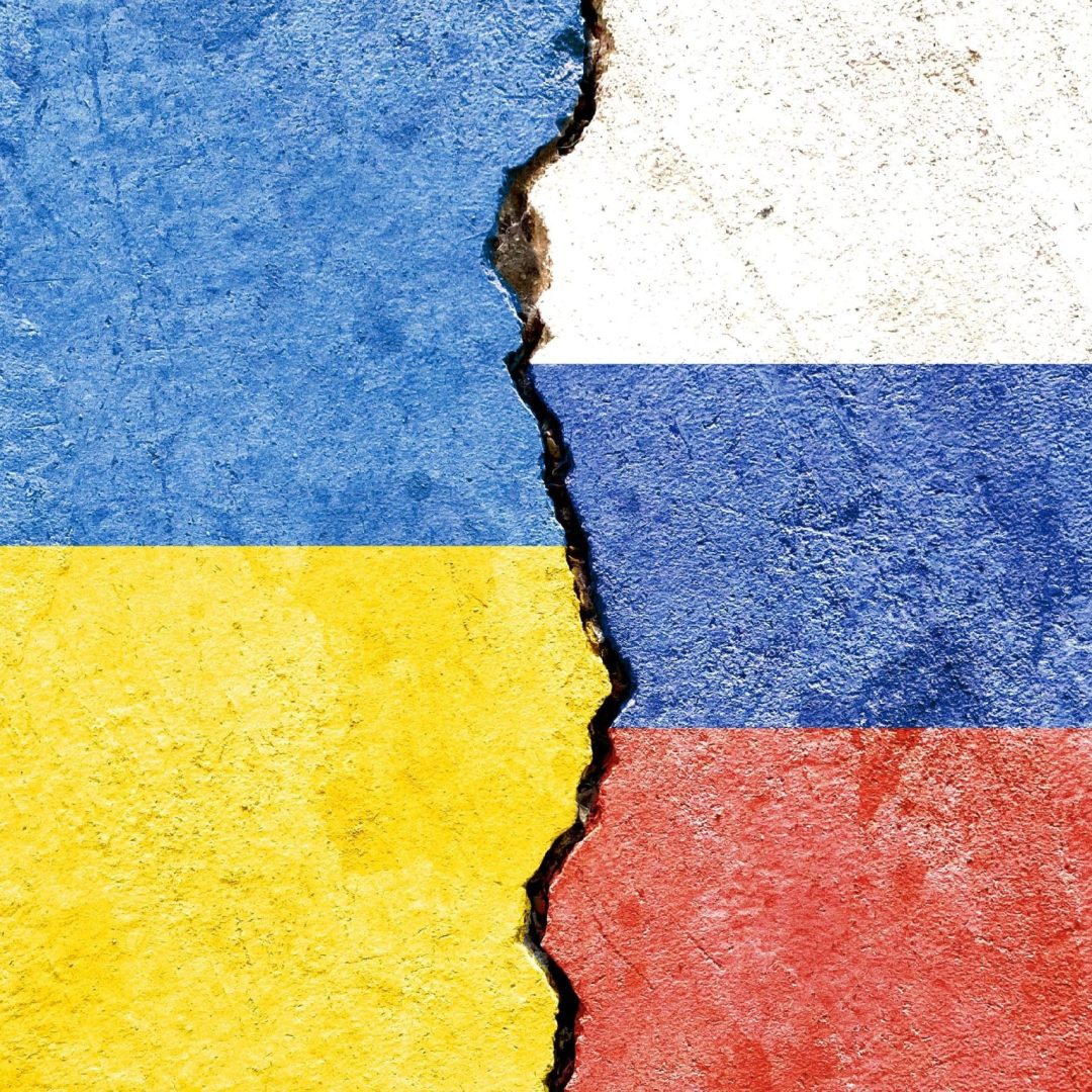 an illustration of the flags of Ukraine and Russia separated by a crack - conflict or comparison