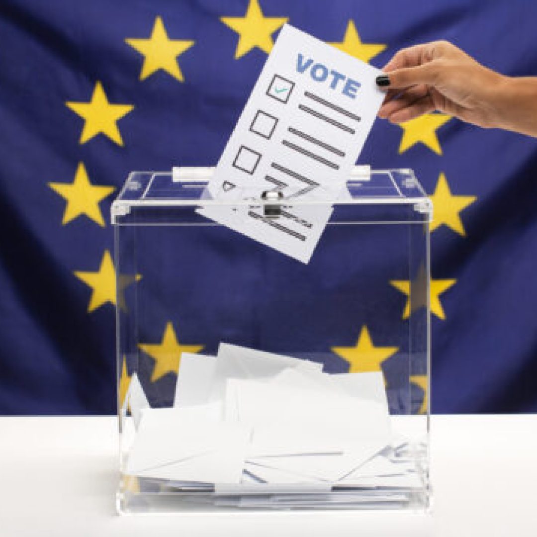 vote-bulletin-held-by-hand-being-put-into-ballot-box